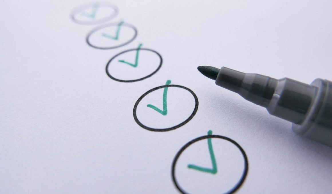 a marker near checked circles on white paper