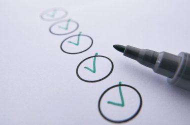 a marker near checked circles on white paper