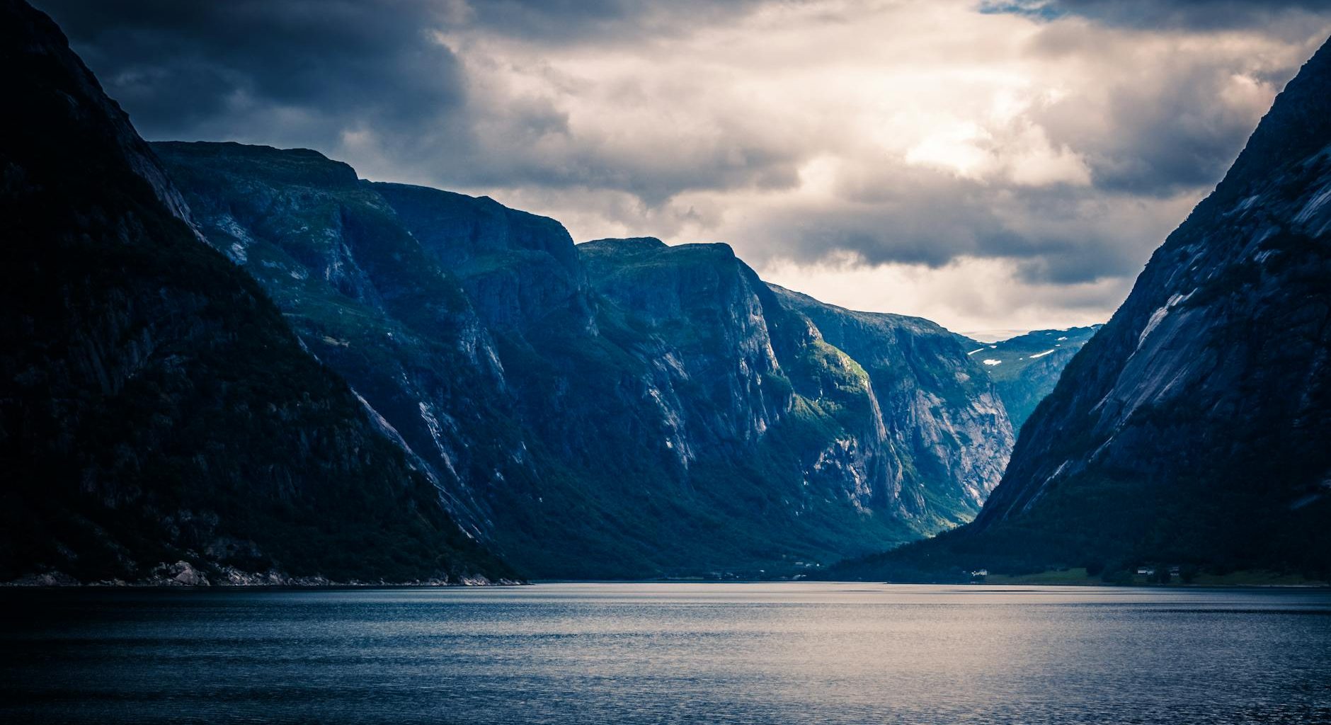 ocean near mountain ranges during sunset
