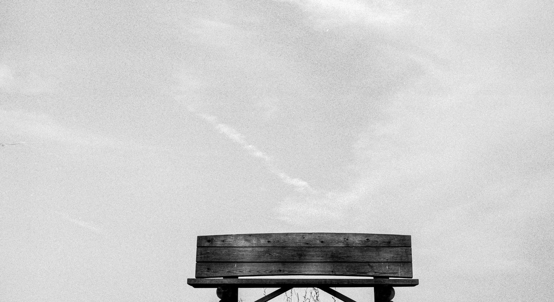 a bench is sitting on top of a hill