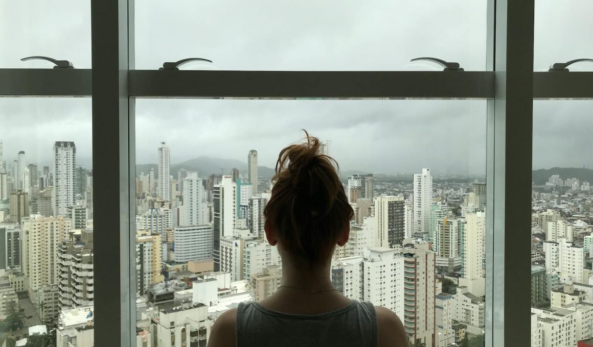 woman standing near glass window
