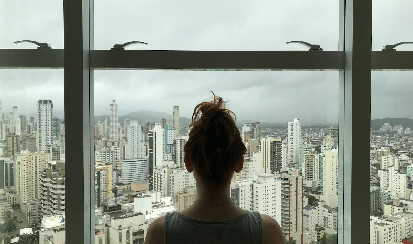 woman standing near glass window