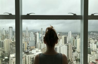 woman standing near glass window