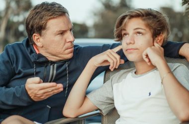 man scolding his son