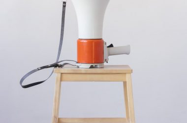 loudspeaker on top of wooden stool