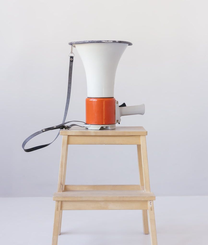 loudspeaker on top of wooden stool