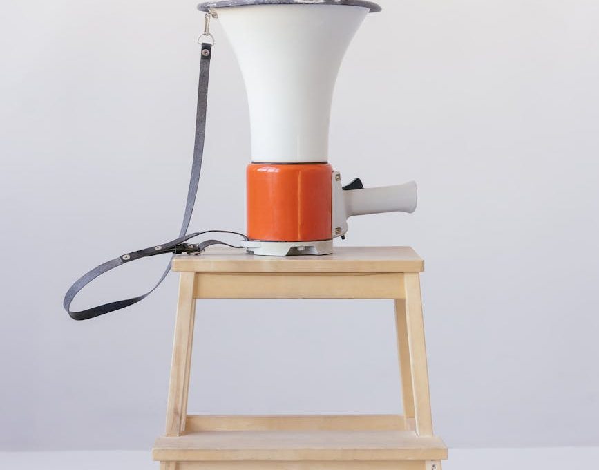 loudspeaker on top of wooden stool