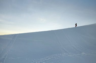 solitary figure on a snowy slope at dusk