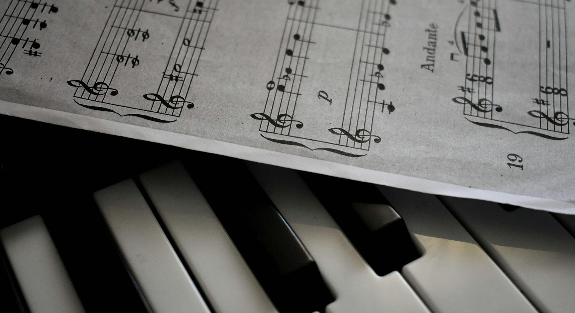 close up shot of musical notes and piano keys