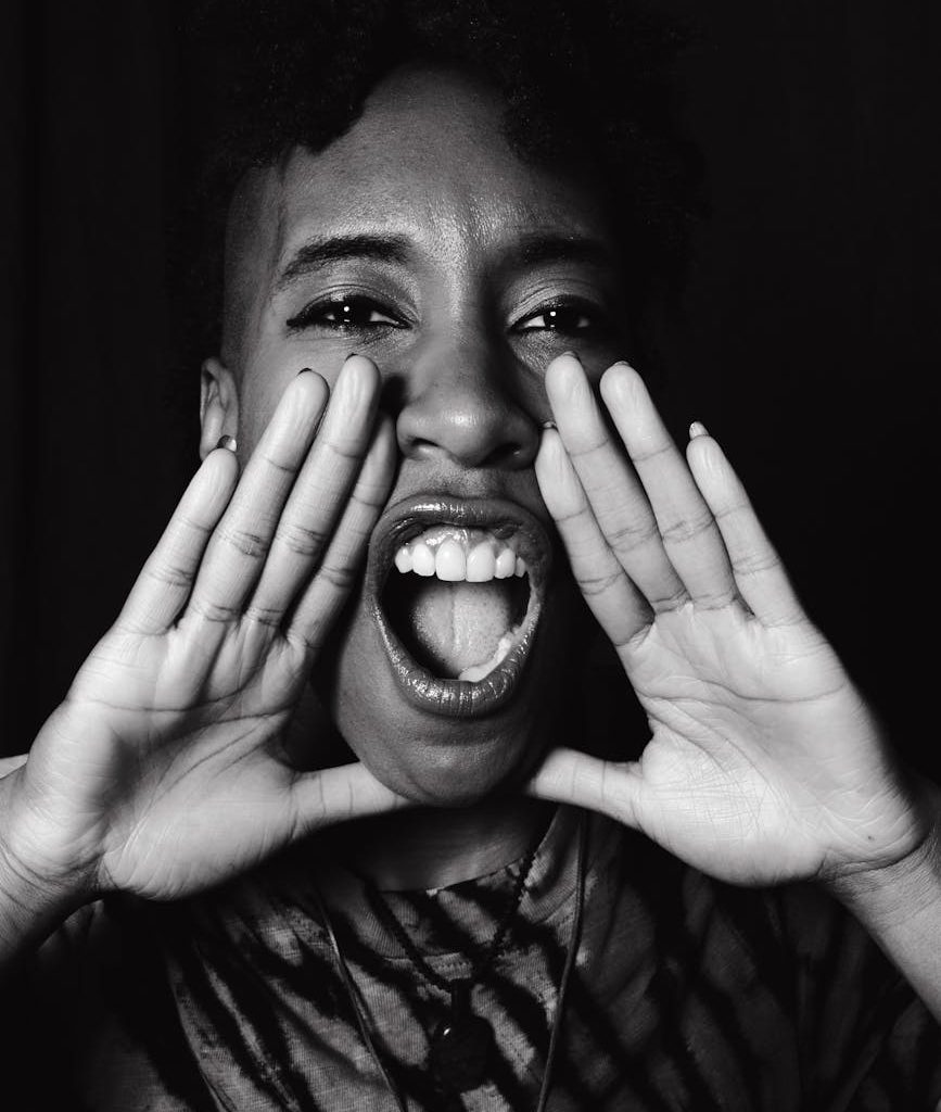 grayscale photo of a woman shouting