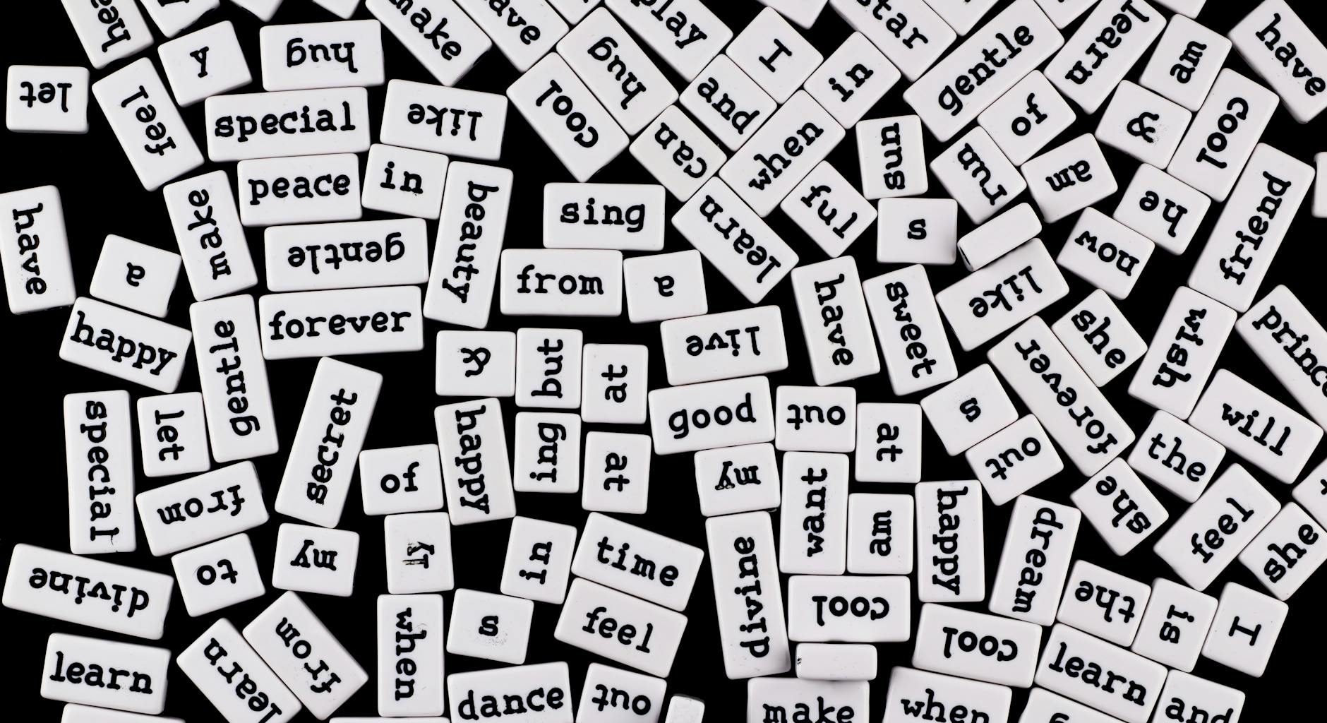 scattered word tiles on black background