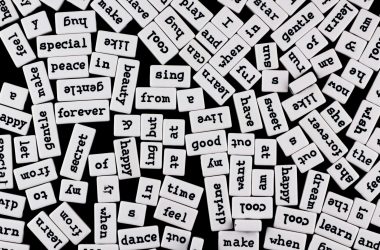scattered word tiles on black background